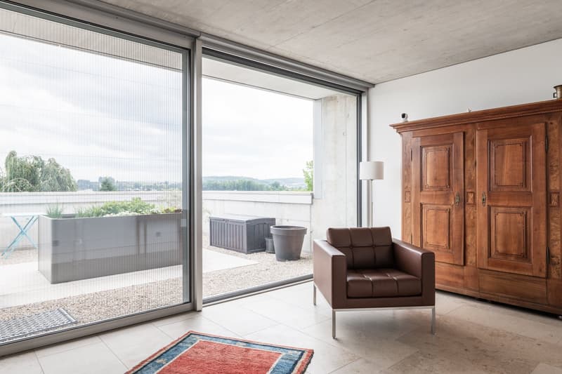 large windows, balcony, wooden floor, wooden furniture, brown leather chair
