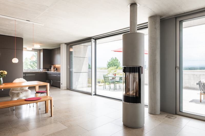 modern design, table with chairs, fireplace, sliding glass doors to balcony