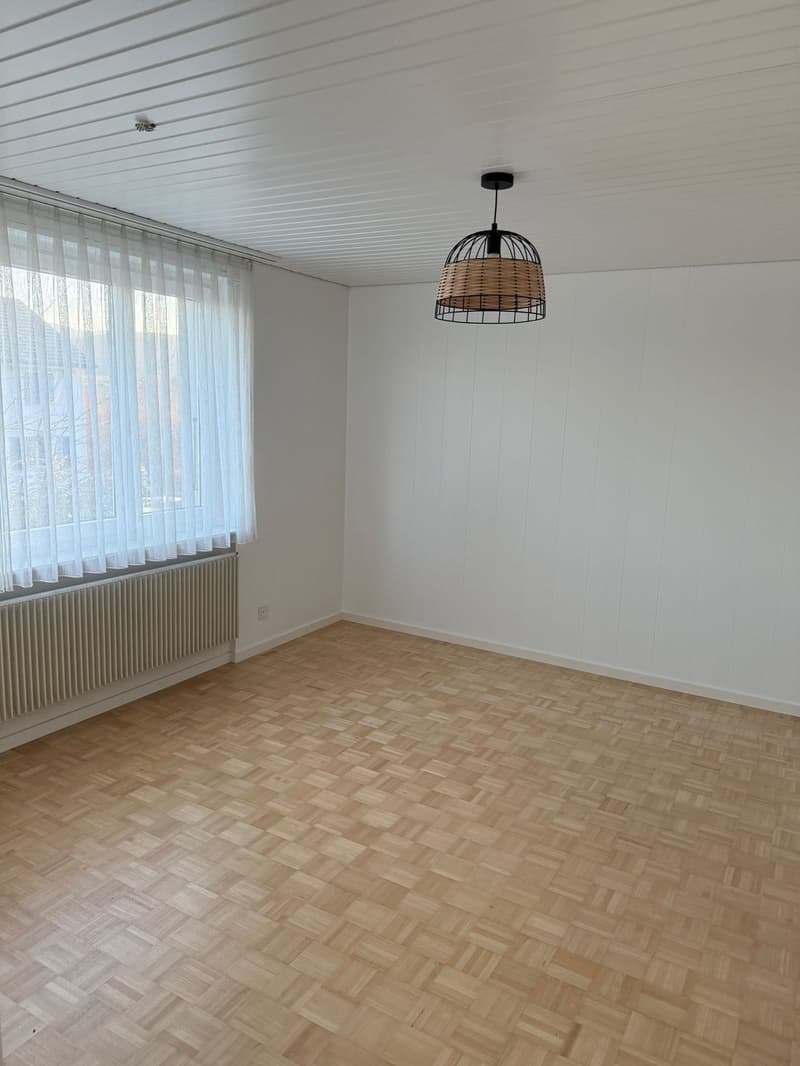 Empty room, white walls, wooden floor, white curtains, radiator, hanging lamp