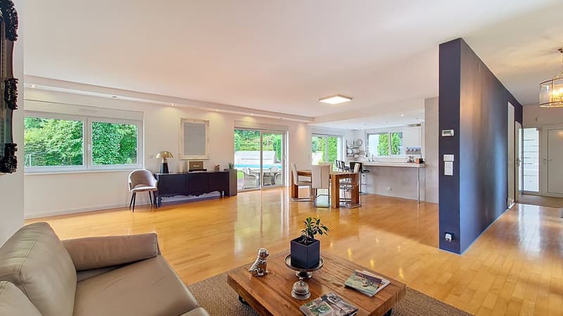 living room, hardwood floors, couch, center table, coffee table, large windows, view of outdoor