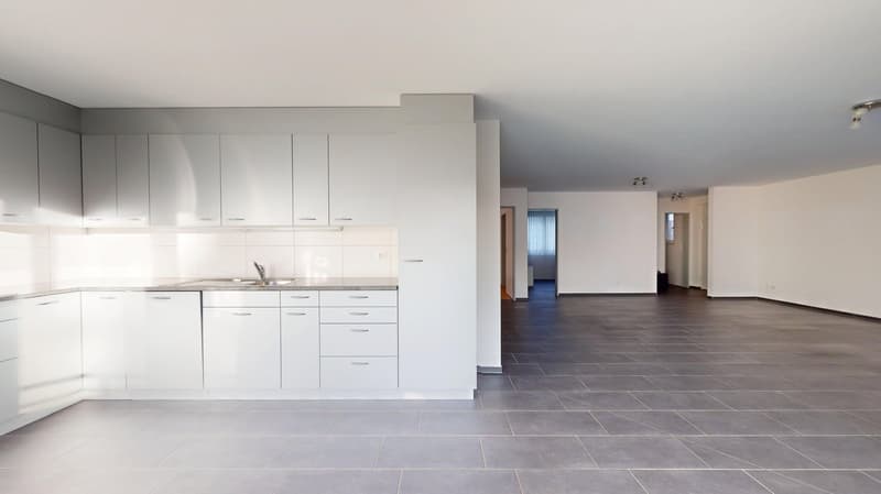 modern kitchen with white cabinets, granite countertops, stainless steel sink, and tiled flooring