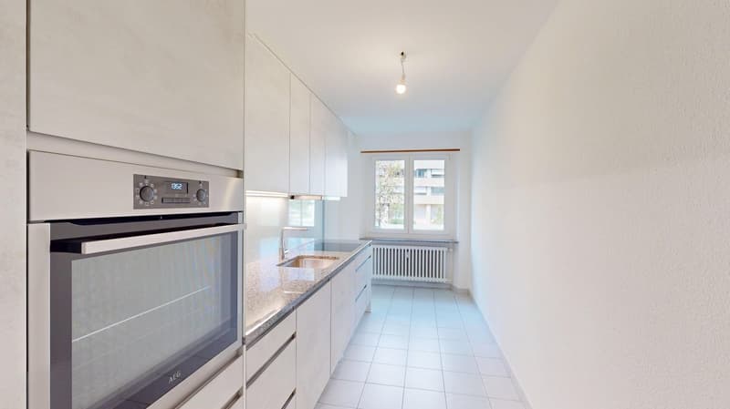 kitchen with oven, double sink, tiled floor, white walls, window