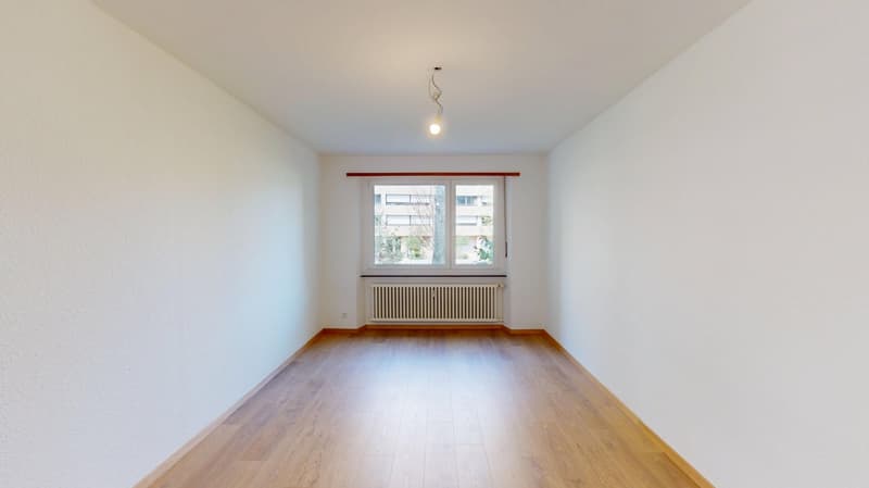 empty room, hardwood floor, white walls, windows, radiator