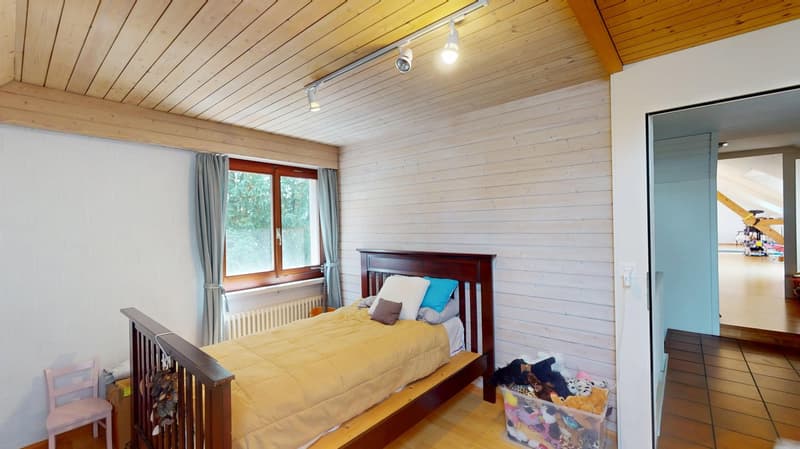 bedroom with bed, wooden ceiling, radiator, wooden floor, storage box with toys