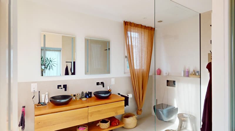 modern bathroom with a double sink vanity, full glass shower, bidet, open shelving, large mirror