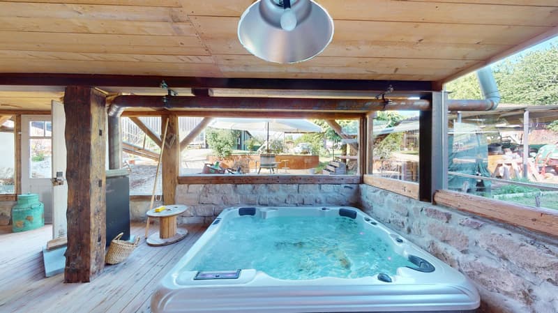outdoor hot tub with stone wall