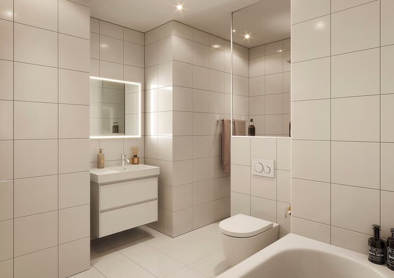 Modern bathroom with white tiles, sink, toilet, bathtub, mirror, lights, towel rack