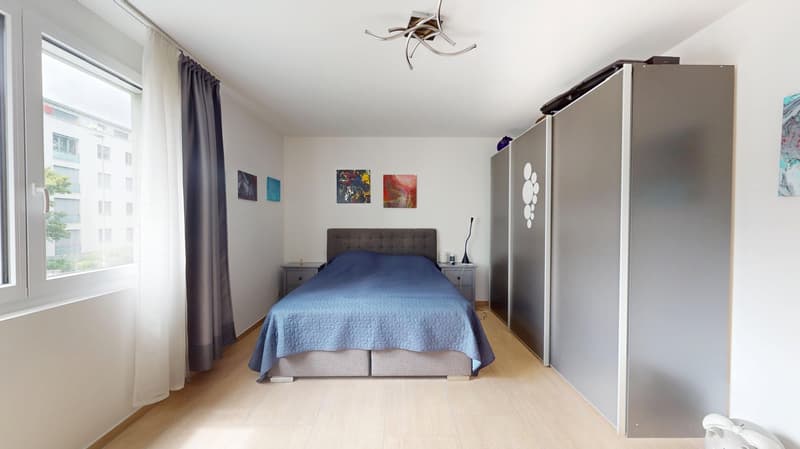 Bedroom with bed, nightstands, wardrobe, window, paintings, wooden floor, ceiling lamp