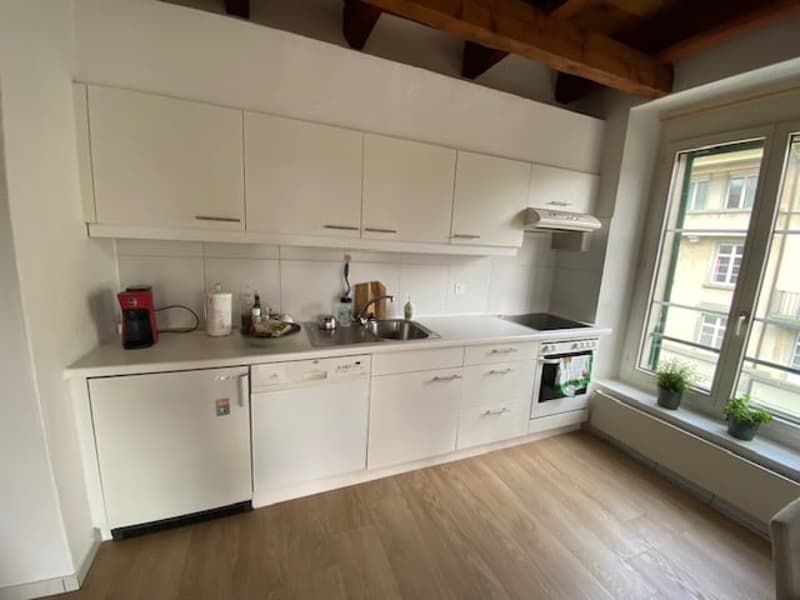 All white cabinets, dishwasher, washing machine, sink, and stovetop
