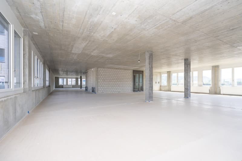 empty interior, concrete ceiling and walls, glass windows, no furniture