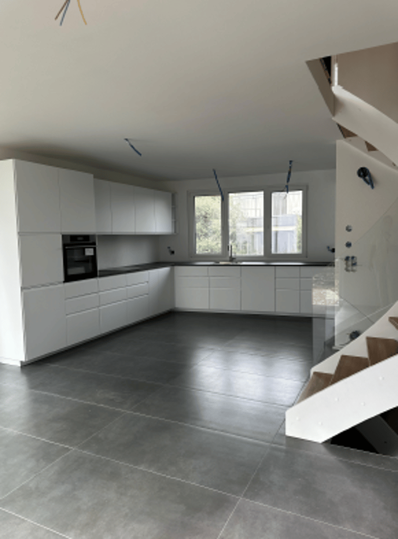 white cabinets, gray tiled floor, built-in oven, sink