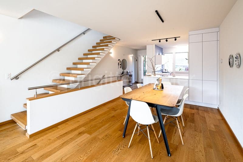 modern living room, hardwood floors, wooden dining table with white chairs, white walls, wooden staircase, white cabinets, modern design