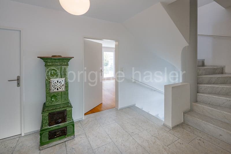 white walls, white tiles, green fireplace, white door, marble stairs