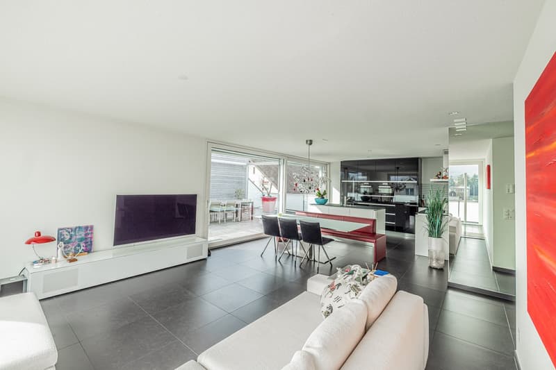 modern living room, white walls, black tile flooring, white couch, TV, dining table, balcony, view