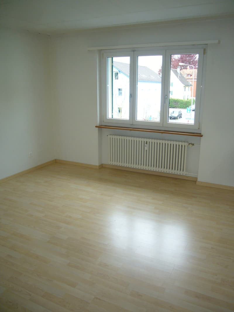 empty room, hardwood floors, two windows, under-window shelf, white radiators