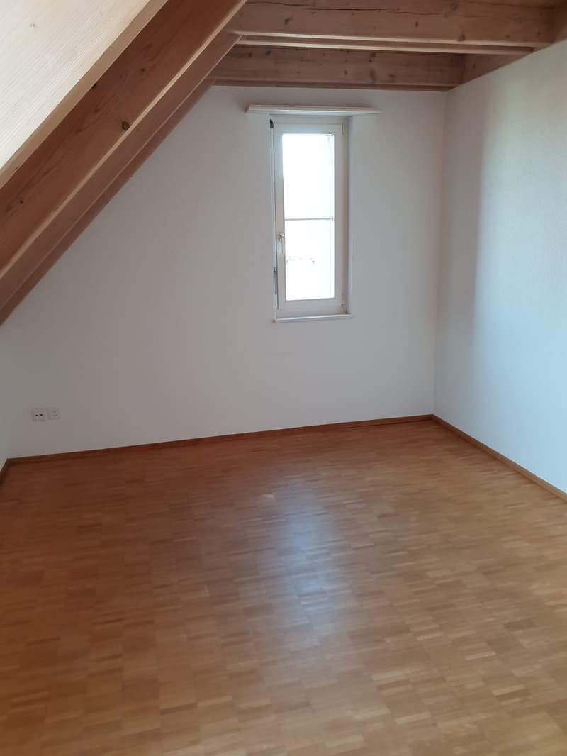 empty room, wooden floor, white walls, small window, wooden ceiling