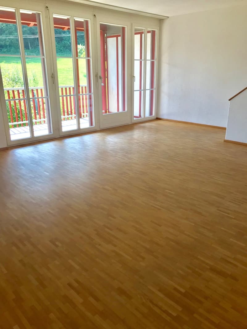empty room, wooden floor, large glass doors, balcony, white walls