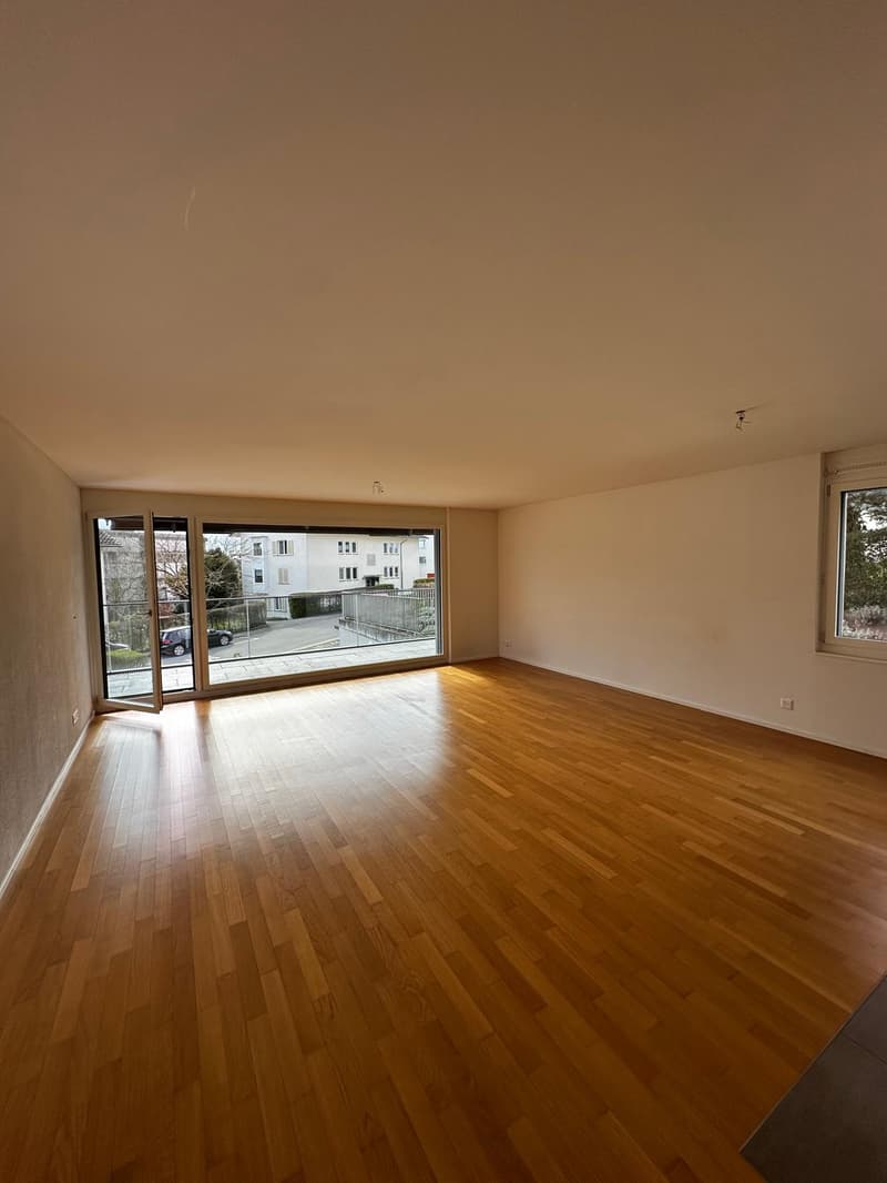 large room, hardwood floors, large windows, balcony, sliding glass doors