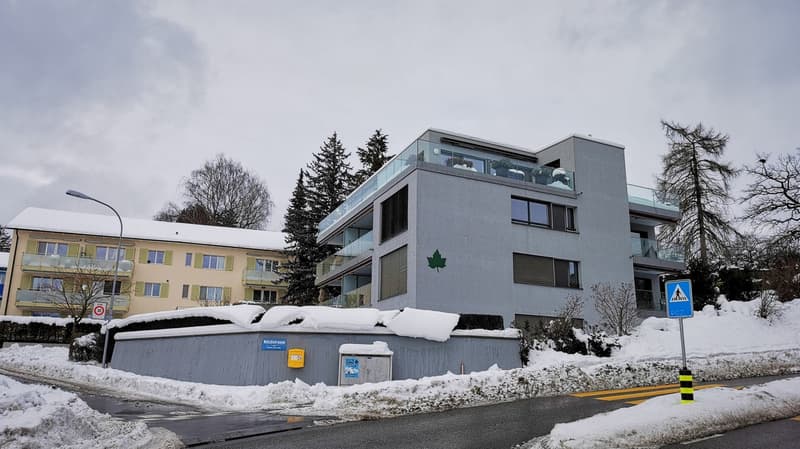 Two story house, snow cover, balcony, windows, wall letter