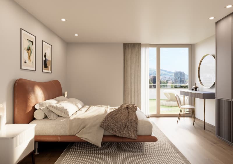 A bedroom with a bed, pillows, and a blanket. There is a desk with a chair and a mirror on the wall. The room has a glass door leading to a balcony with a view of the city.