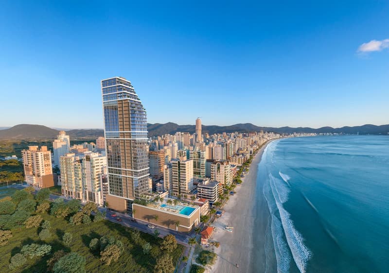High-rise building with glass facade, swimming pool on the rooftop, surrounded by other buildings, beach, and ocean