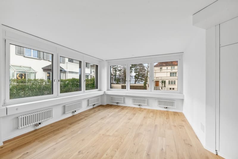 empty room, wooden floor, white walls, large windows, radiators