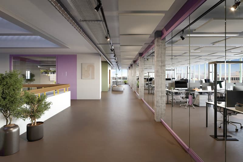 office corridor, brown tiles, white ceiling, gray walls, glass partitions, interior plants, multiple desks and office chairs, computer monitors, office plants, windows, track lighting
