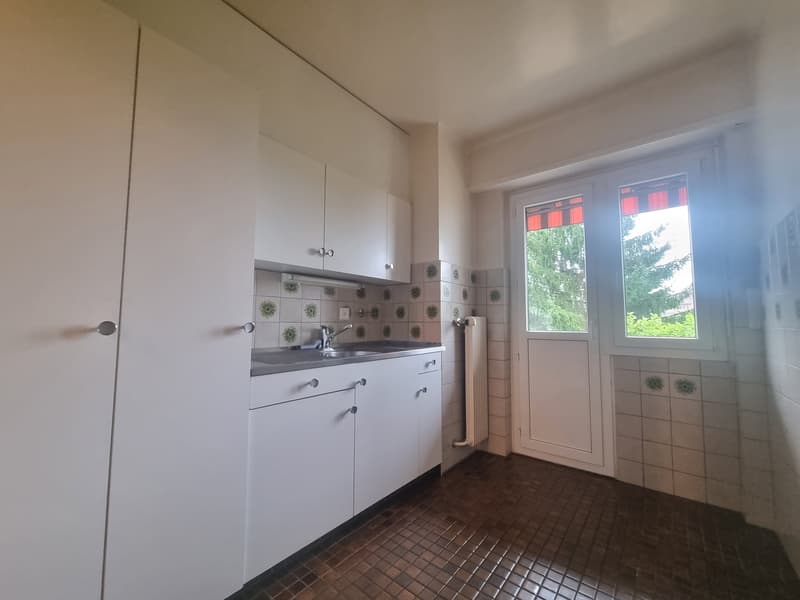 white kitchen cabinets, stainless steel sink, faucet, tiled walls, floor