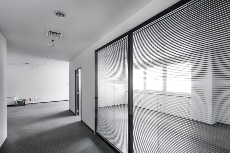 empty office room, carpet floor, glass doors, air vents