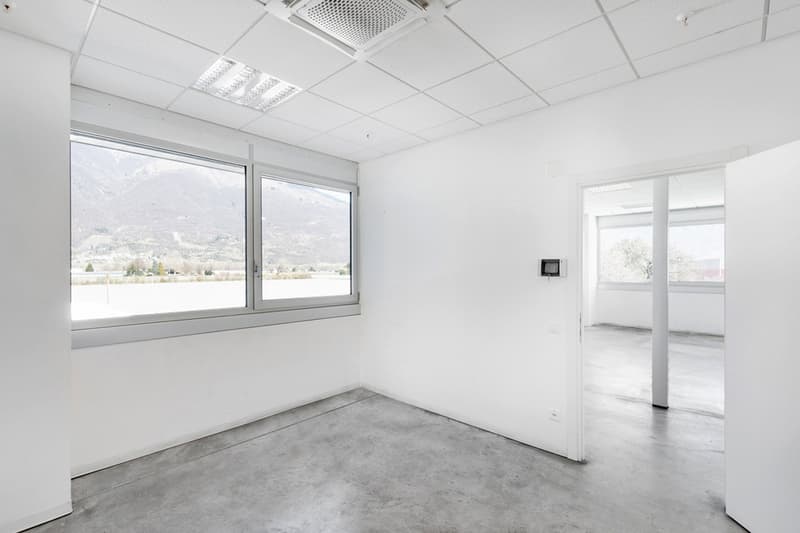 modern office room, clean walls, gray floor, large windows, mountain view