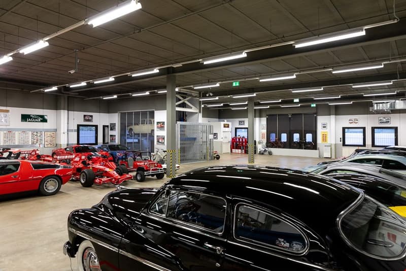a showroom with several vehicles and many lights