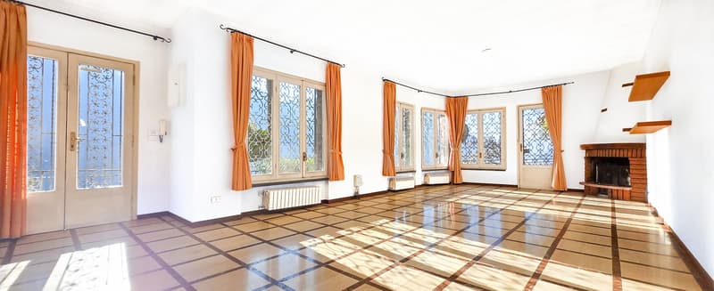 large room, fireplace, tile floor, windows, radiator, wooden floors