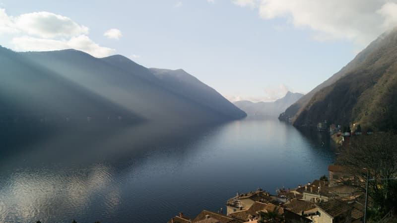 lake with mountains in the background, small village
