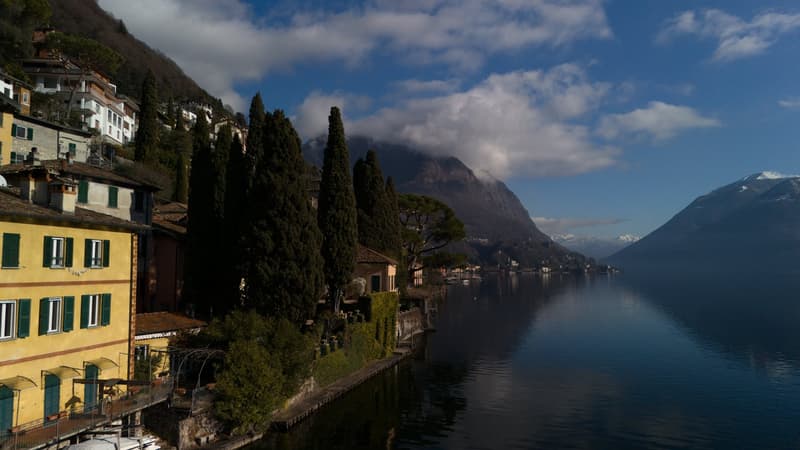 Lakeside view, trees, mountain, houses on a hillside, boat
