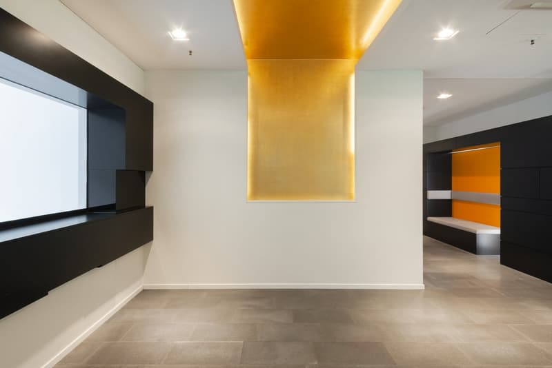 modern room, white walls, black and yellow accents, large window, tiled floor