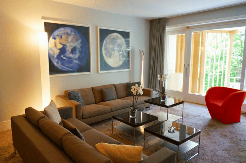 two couches, large windows, wooden floor, modern decor, terrace visible