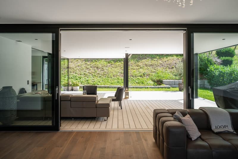 wood floor, leather sofa, wooden balcony, green landscape