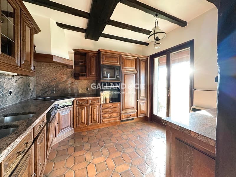 modern kitchen, wooden cabinets, granite countertops, stainless steel appliances, tiled floor, glass doors