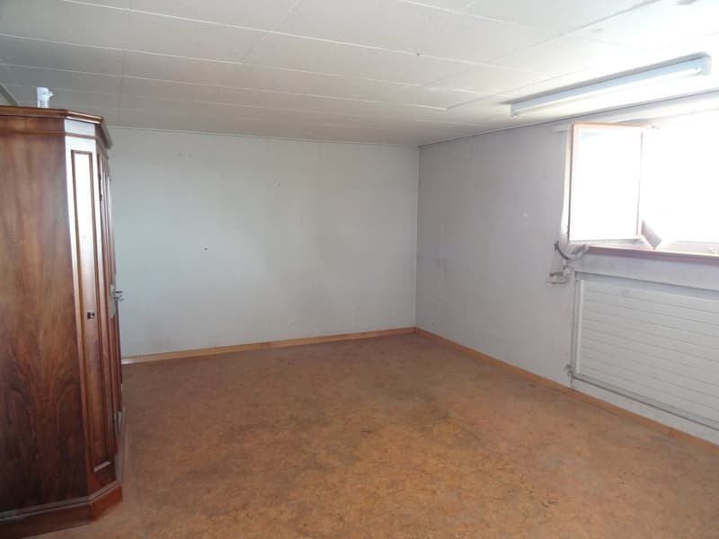 Empty room with wooden wardrobe, floor, window, radiator, ceiling lamp