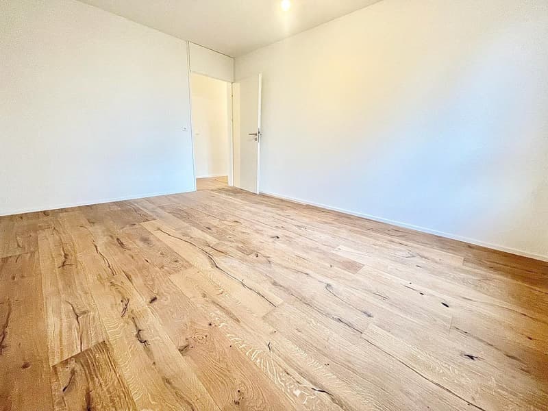 empty room, wooden floor, white walls, open door