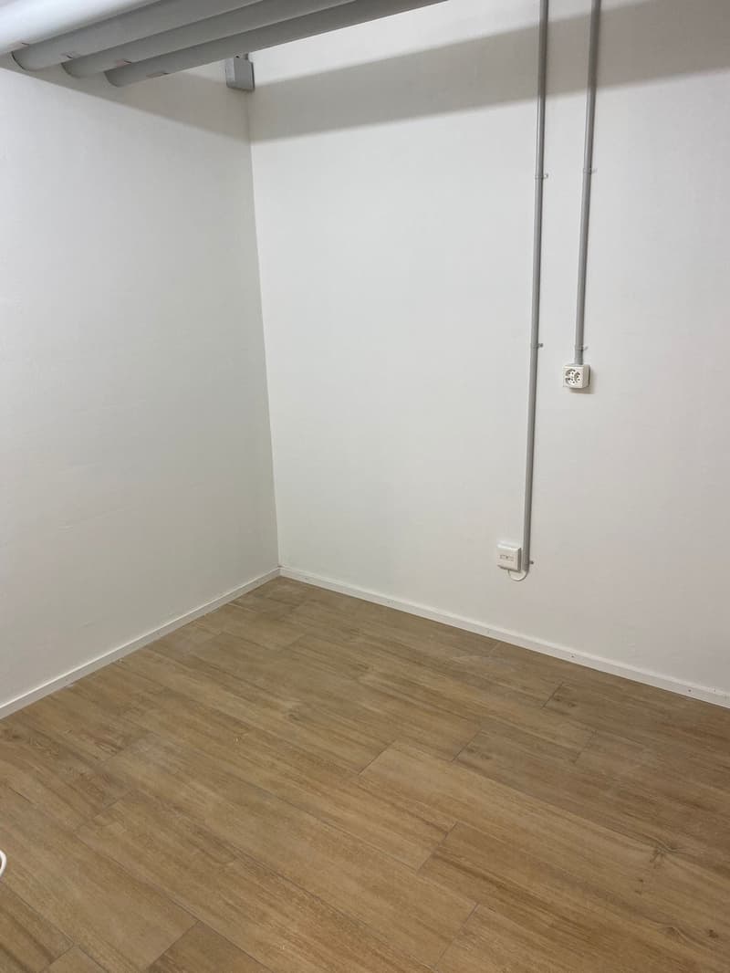 An empty room with white walls and wooden floor