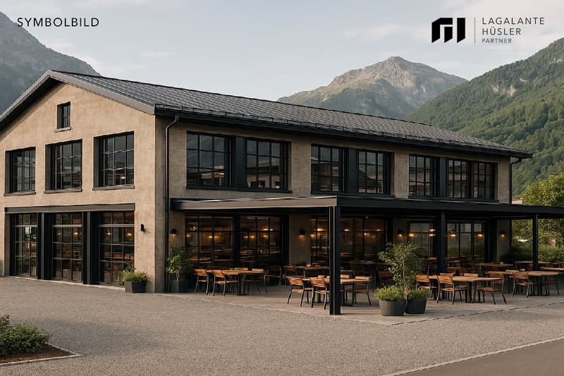 modern building, large windows, outdoor seating area, surrounded by mountains