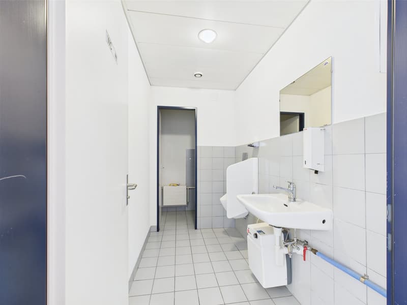 tiled flooring, white walls, mirror, sink, urinal, toilet