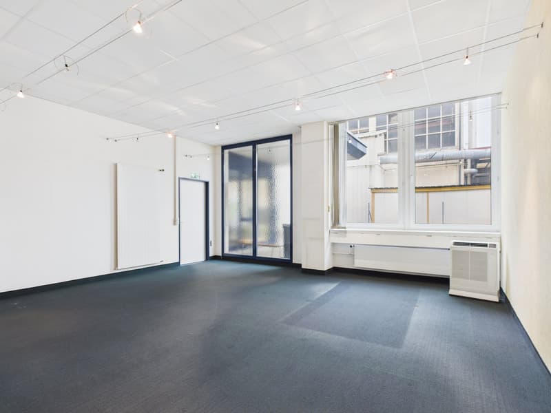 empty room, glass doors, white walls, black floor, suspended lighting, windows