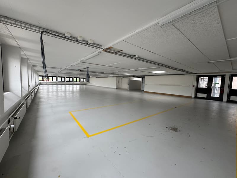 empty parking space, white walls, white ceiling, yellow lines, cables