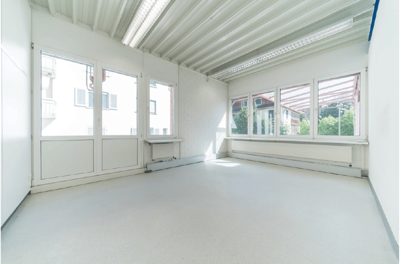 large windows with white frames, tiled floor, white walls