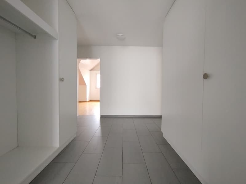 empty room, tiled floor, white walls, ceiling lamp, closets