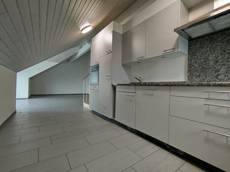 Empty kitchen, gray tile flooring, white cabinetry, stainless steel faucet, granite countertop