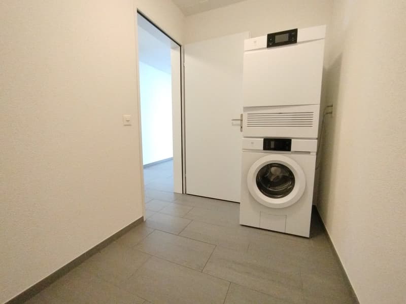 laundry room with a stacked washing machine and dryer