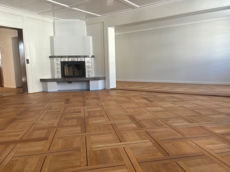 empty room, parquet flooring, white walls, fireplace
